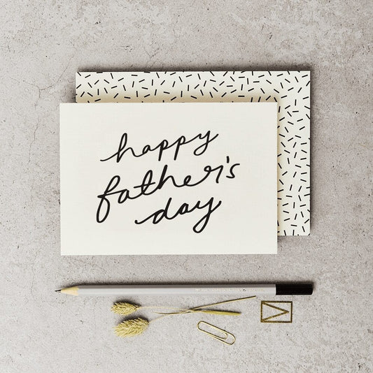 White card landscape with happy Father’s Day in black script handwriting 
