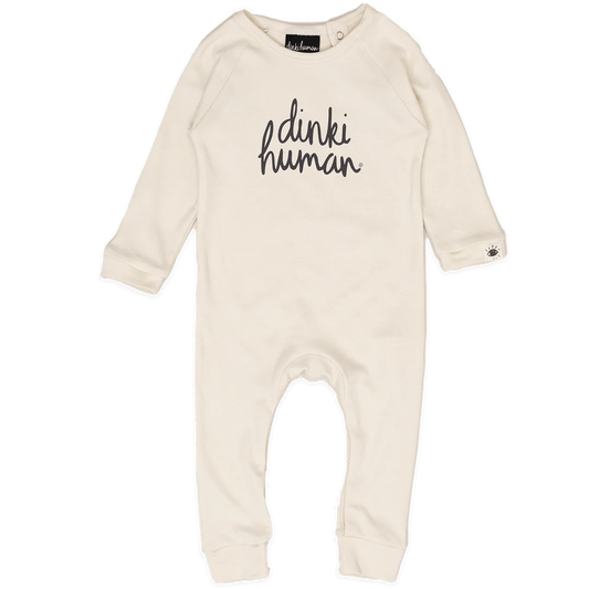 Cream natural organic cotton long sleeved footless baby grow romper with dinki human across the front in black charcoal cursive print and a tiny label stitched on the cuff with an eye sketched in black charcoal inside black label embroidered with dinki human in cream