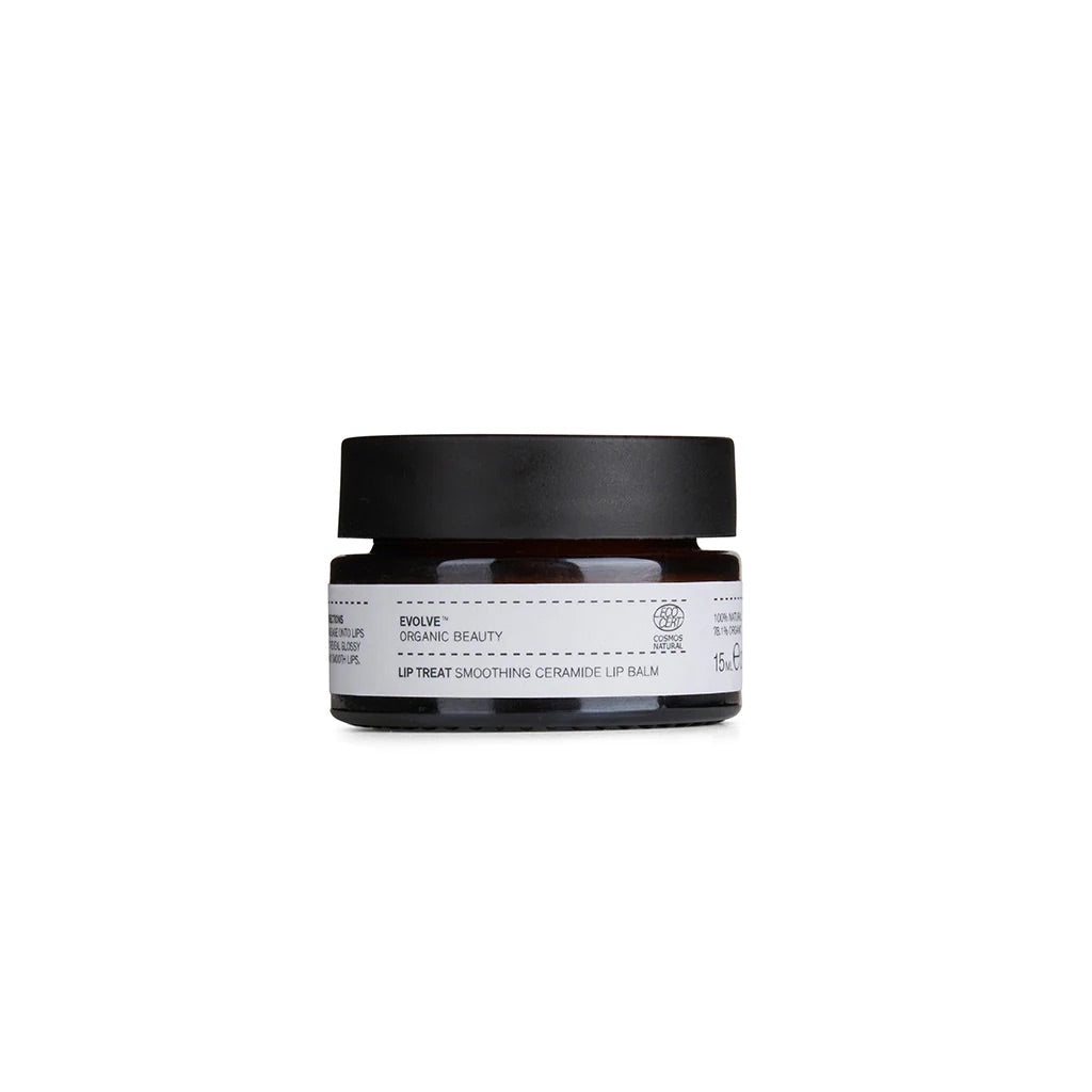 Small flat amber dark brown glass jar with black lid with white label black print EVOLVE ORGANIC BEAUTY LIP TREAT SMOOTHING CERAMIDE LIP BALM with Vegan logo and Leaping Bunny logo