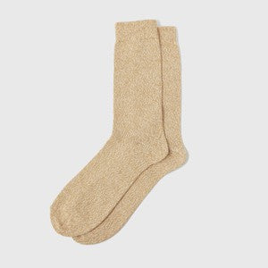Pair of pale yellow and white marl speckled organic cotton socks on a white background